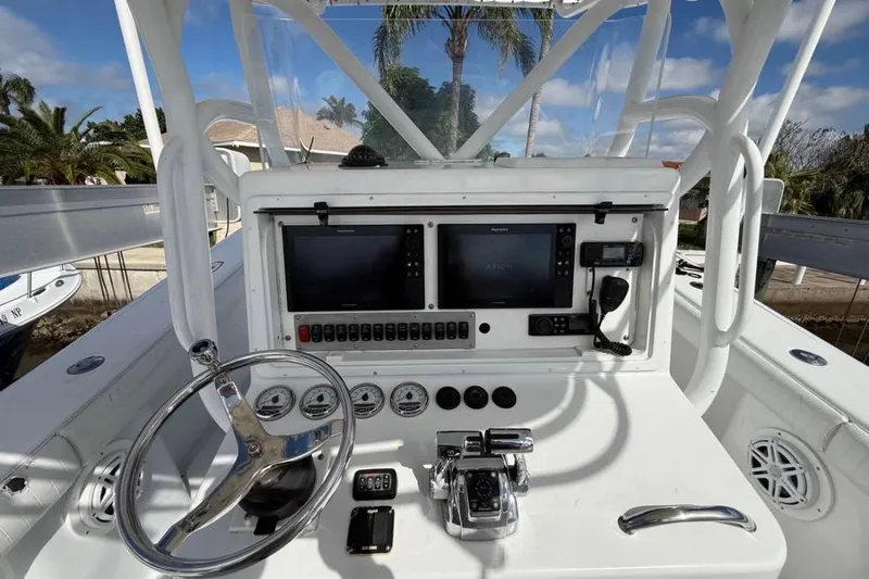  Yacht Photos Pics 2004 Yellowfin 36 Offshore boat dashboard with steering wheel and navigation equipment.