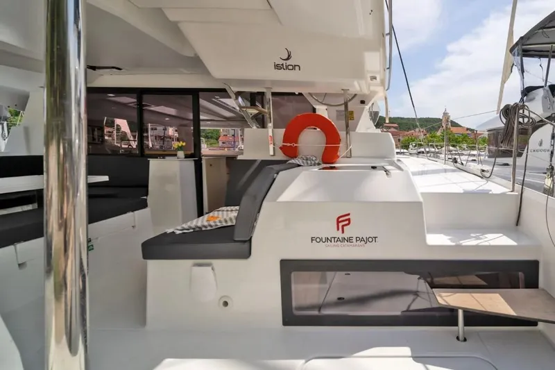 First Life Yacht Photos Pics 2025 Fountaine Pajot Tanna 47 catamaran interior with seating and life preserver.
