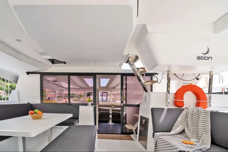 First Life Yacht Photos Pics Interior of 2025 Fountaine Pajot Tanna 47 catamaran with modern seating and dining area.