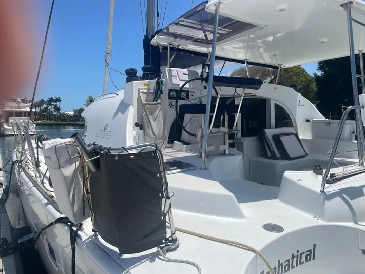 Seabatical Yacht Photos Pics 2016 Lagoon 380 catamaran docked, featuring spacious deck and seating area.