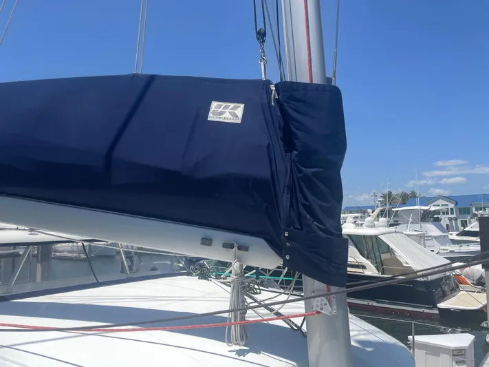 Seabatical Yacht Photos Pics 2016 Lagoon 380 sailboat with blue sail cover, docked at marina under clear sky.