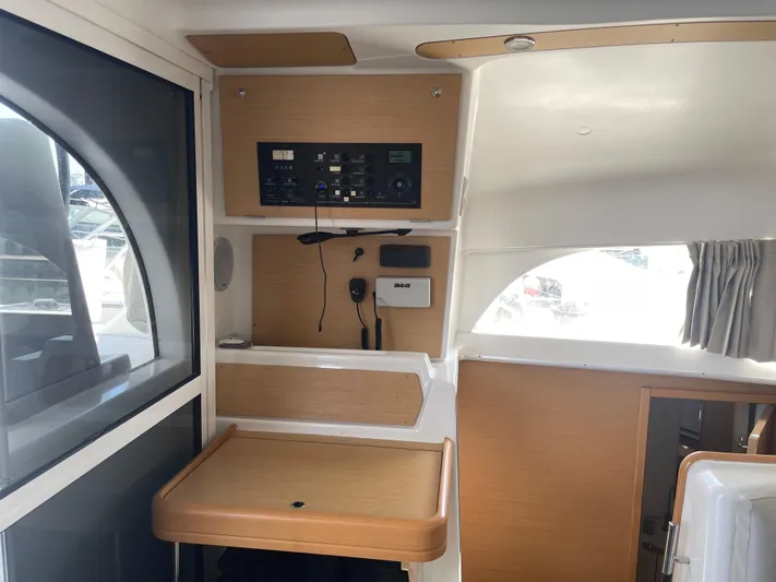 Seabatical Yacht Photos Pics Interior of 2016 Lagoon 380 catamaran with navigation equipment and wooden accents.
