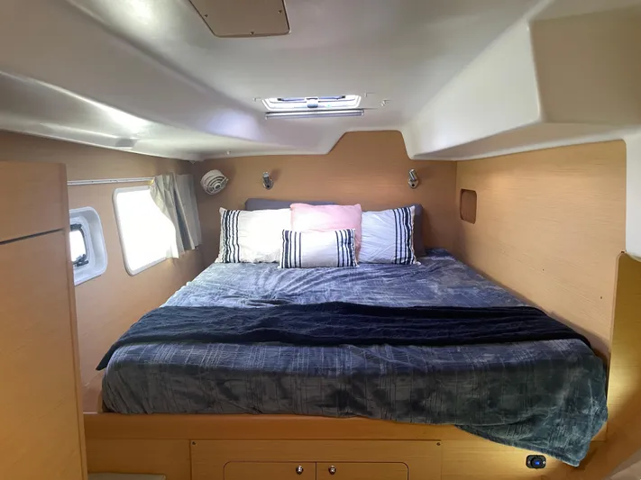 Seabatical Yacht Photos Pics Cozy cabin interior of 2016 Lagoon 380 catamaran with comfortable bedding and natural light.