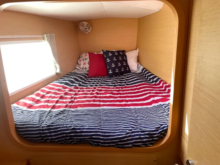 Seabatical Yacht Photos Pics Cozy cabin bed in 2016 Lagoon 380 catamaran with nautical-themed bedding.