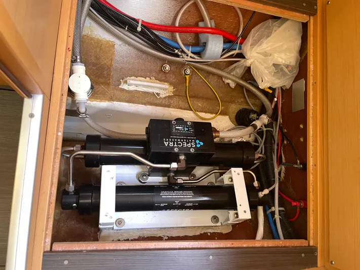 Seabatical Yacht Photos Pics Water filtration system in a 2016 Lagoon 380 boat, featuring various pipes and cables.