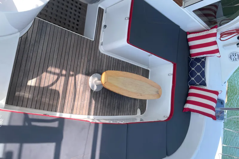 Seabatical Yacht Photos Pics Lagoon 380 catamaran interior with wooden table, striped cushions, and sleek seating, 2016 model.