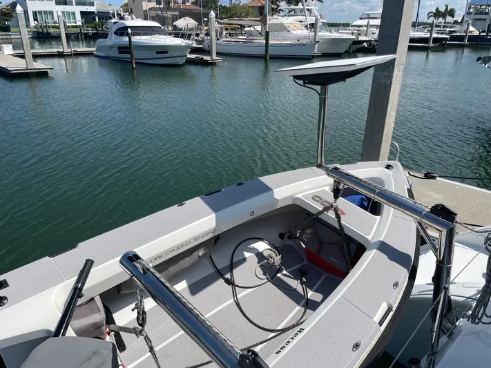 Seabatical Yacht Photos Pics 2016 Lagoon 380 catamaran docked at marina, showcasing helm and seating area.