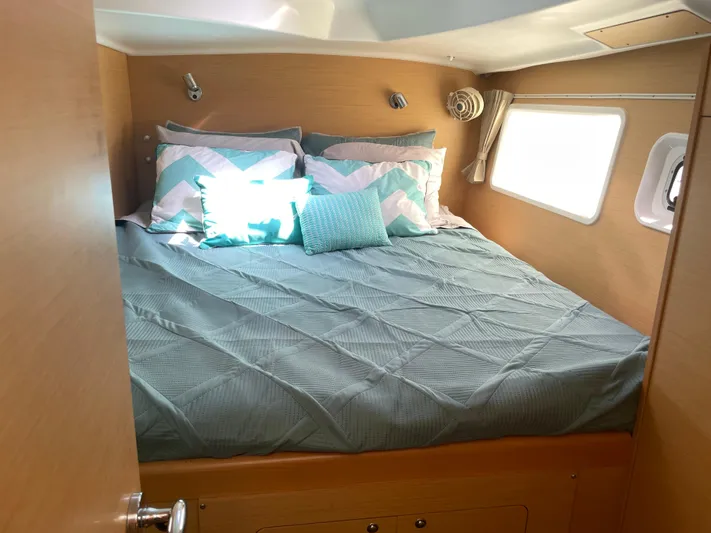 Seabatical Yacht Photos Pics Cozy bedroom in 2016 Lagoon 380 catamaran with teal bedding and natural light.