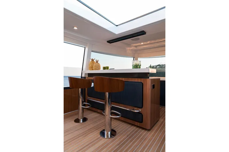  Yacht Photos Pics Luxurious interior of 2027 Sirena 78 yacht with modern bar stools and sleek design.