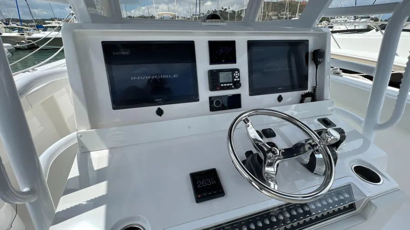 Warevel Yacht Photos Pics Cockpit of 2019 Invincible 40 Catamaran with dual screens and steering wheel.