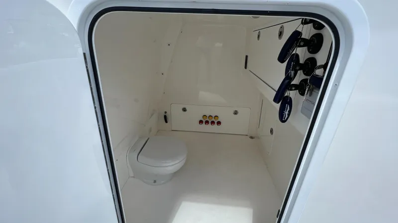 Warevel Yacht Photos Pics Interior of 2019 Invincible 40 Catamaran, featuring a compact marine toilet and control panel.