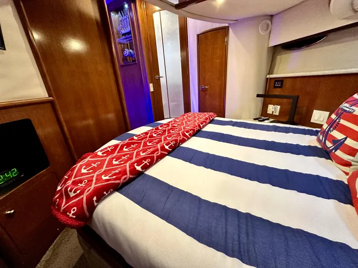 Journey Yacht Photos Pics 1999 Carver 450 Pilothouse bedroom with nautical-themed bedding.