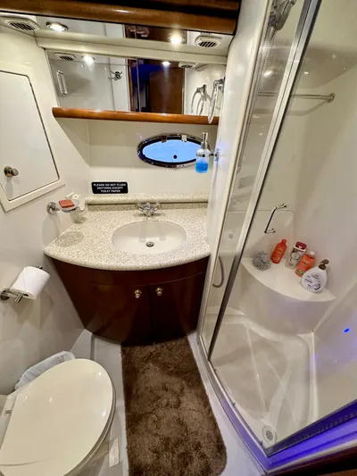 Journey Yacht Photos Pics 1999 Carver 450 Pilothouse bathroom with shower, sink, and toilet.