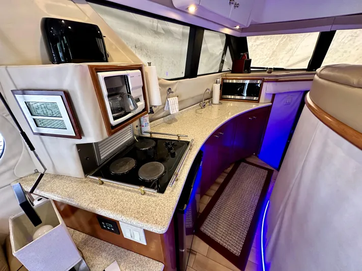 Journey Yacht Photos Pics 1999 Carver 450 Pilothouse yacht kitchen with modern appliances and curved countertops.