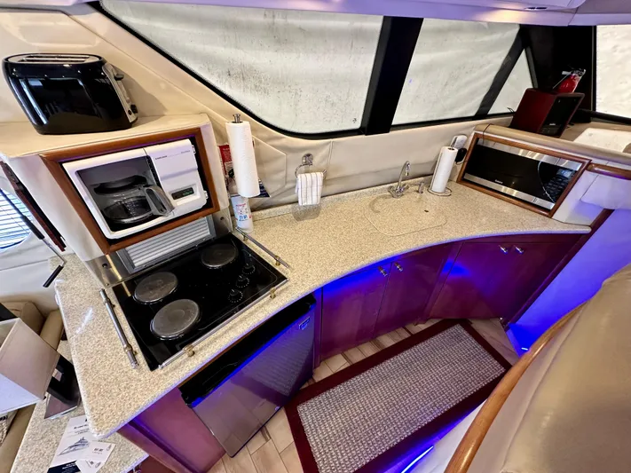 Journey Yacht Photos Pics Carver 450 Pilothouse 1999 yacht kitchen with stove, microwave, and coffee maker.