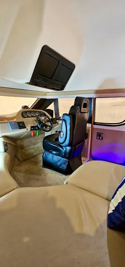 Journey Yacht Photos Pics Interior of a 1999 Carver 450 Pilothouse yacht with captain's chair and control panel.