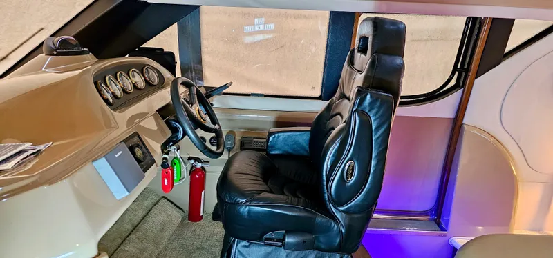 Journey Yacht Photos Pics 1999 Carver 450 Pilothouse interior with captain's chair and control panel.