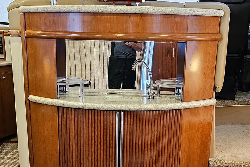 Journey Yacht Photos Pics 1999 Carver 450 Pilothouse interior with wooden cabinetry and sink.