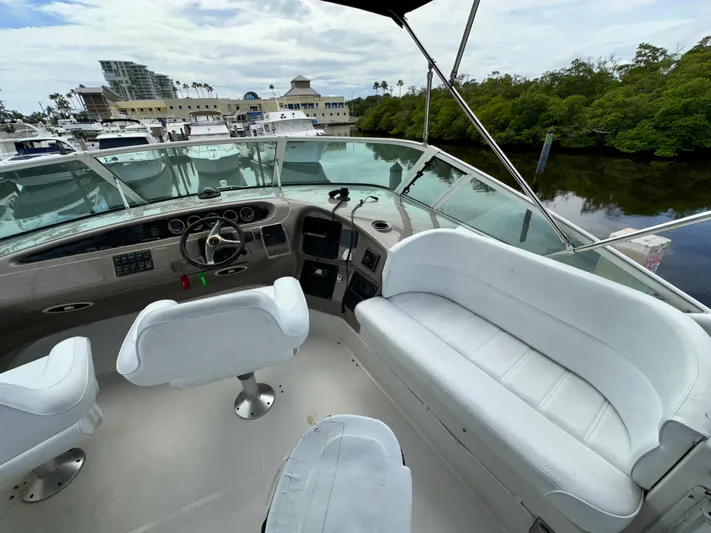 Journey Yacht Photos Pics 1999 Carver 450 Pilothouse boat interior with white seating and control panel.