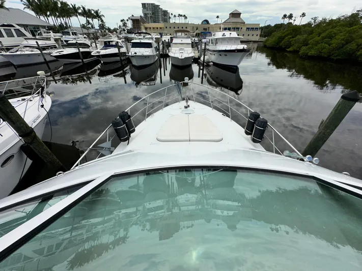 Journey Yacht Photos Pics 1999 Carver 450 Pilothouse yacht docked at a marina with other boats.