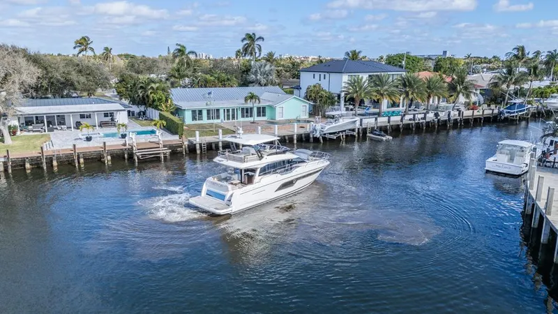 Happy Cay Yacht Photos Pics Prestige 520 Flybridge yacht cruising near waterfront homes, 2021 model.