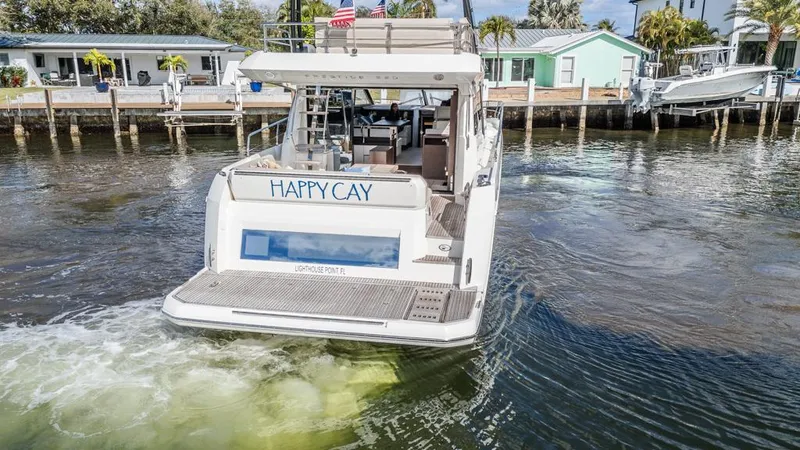 Happy Cay Yacht Photos Pics Prestige 520 Flybridge 2021 yacht "Happy Cay" cruising near waterfront homes.