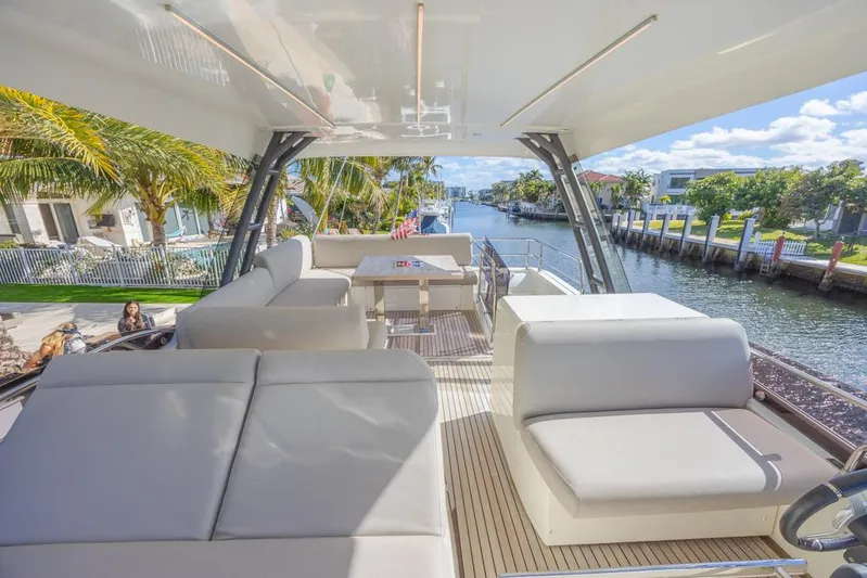 Happy Cay Yacht Photos Pics Luxurious 2021 Prestige 520 Flybridge yacht with spacious seating and scenic waterway view.