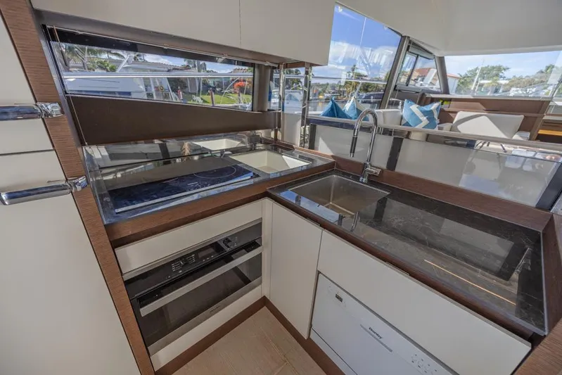 Happy Cay Yacht Photos Pics Modern kitchen interior of 2021 Prestige 520 Flybridge yacht with sleek design and appliances.