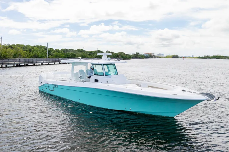  Yacht Photos Pics 2026 HCB 42 Lujo boat on calm water, featuring sleek design and turquoise hull.