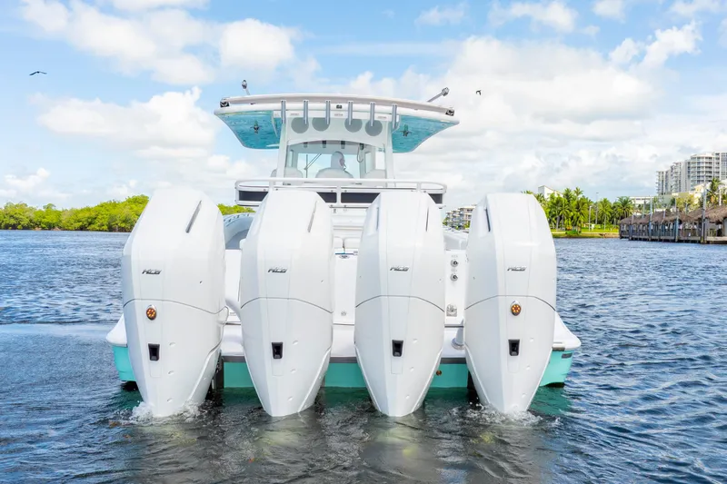  Yacht Photos Pics 2026 HCB 42 Lujo boat with four powerful outboard engines on a sunny day.