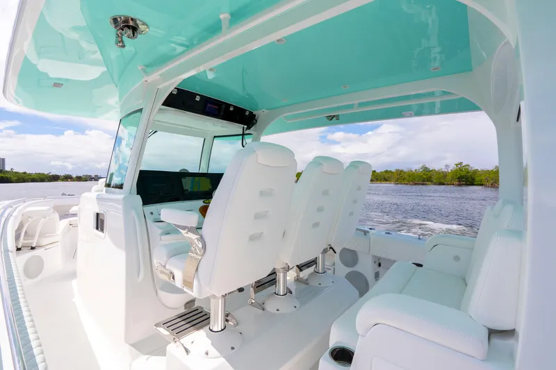  Yacht Photos Pics 2026 HCB 42 Lujo boat interior with white seating and turquoise canopy on a sunny day.
