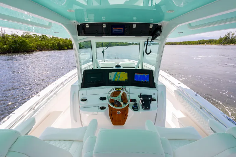  Yacht Photos Pics 2026 HCB 42 Lujo boat interior with advanced navigation system on a serene waterway.