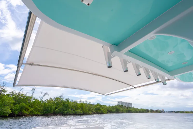  Yacht Photos Pics 2026 HCB 42 Lujo boat with sleek canopy, cruising on a scenic waterway.
