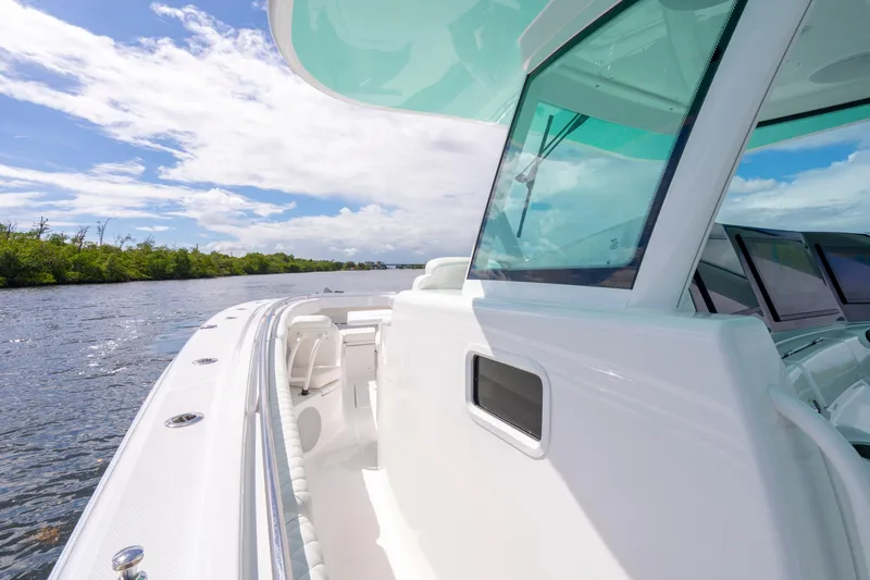  Yacht Photos Pics 2026 HCB 42 Lujo boat cruising on a scenic waterway under a clear blue sky.
