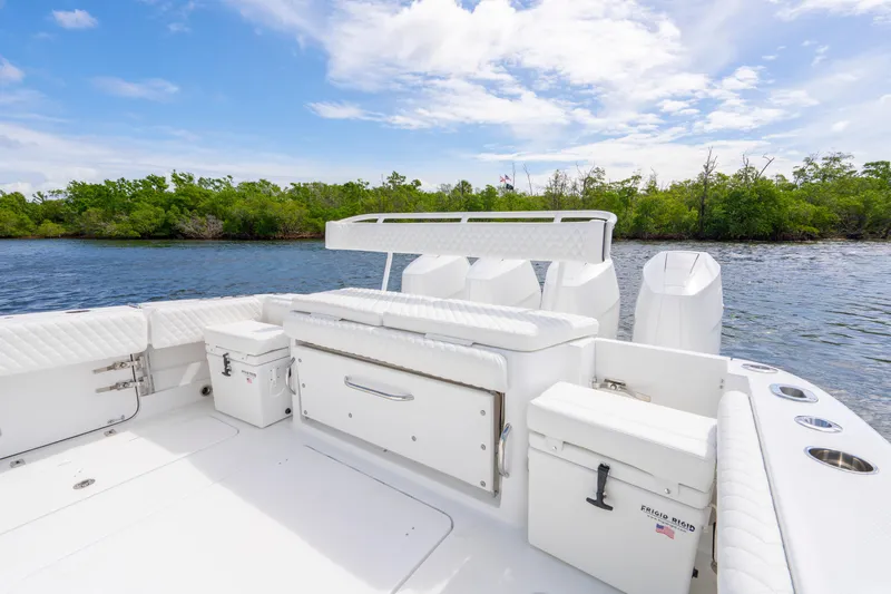  Yacht Photos Pics 2026 HCB 42 Lujo boat with white seating, on a serene waterway with lush greenery.