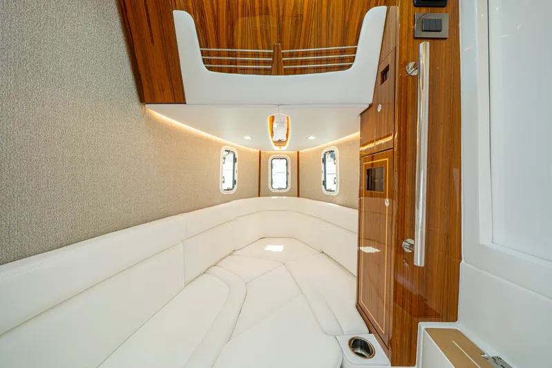  Yacht Photos Pics Luxurious interior of 2026 HCB 42 Lujo yacht with elegant wood and white seating.