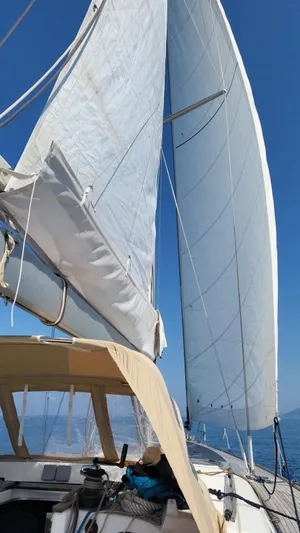 Refit Totale Anno 2023/2024 Yacht Photos Pics Sailing on a 2007 Dufour 525 Grand Large yacht with full sails under clear blue skies.