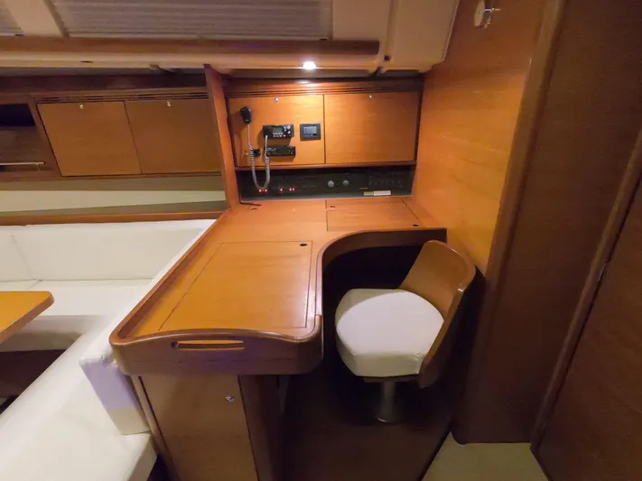 Refit Totale Anno 2023/2024 Yacht Photos Pics Interior of 2007 Dufour 525 Grand Large yacht with wooden desk and seating area.