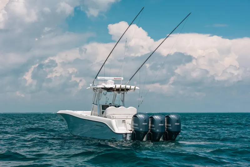  Yacht Photos Pics 2008 Hydra-Sports Vector 3300 CC boat on open sea with cloudy sky.