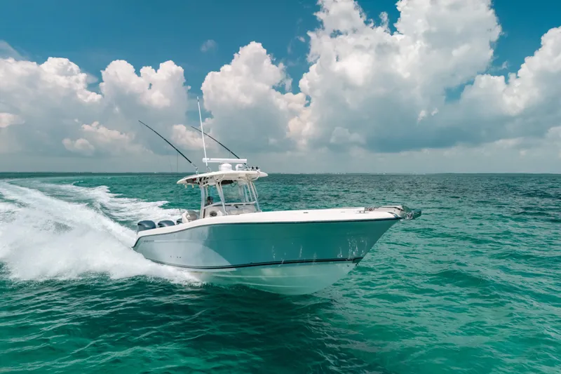  Yacht Photos Pics 2008 Hydra-Sports Vector 3300 CC cruising on turquoise ocean under cloudy sky.