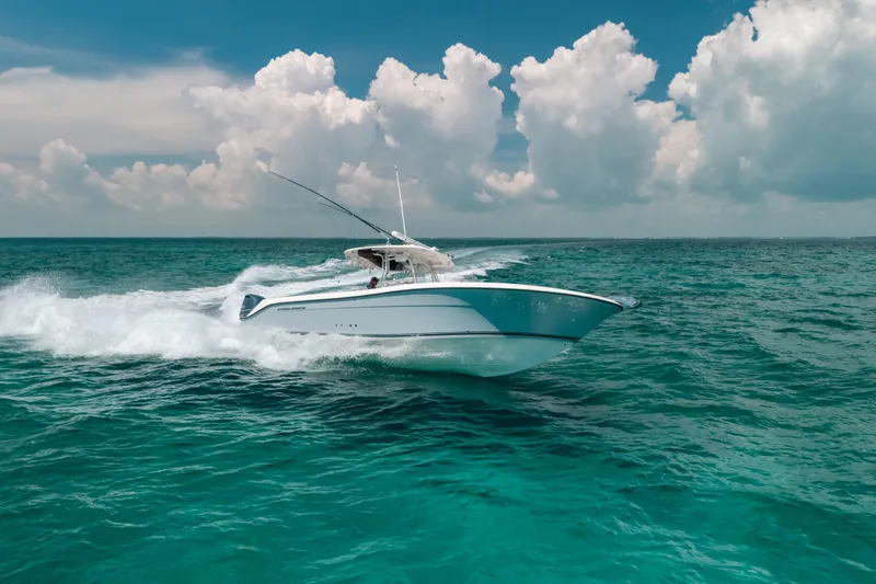  Yacht Photos Pics 2008 Hydra-Sports Vector 3300 CC cruising on open ocean under cloudy sky.