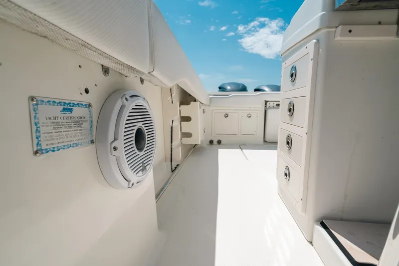  Yacht Photos Pics 2008 Hydra-Sports Vector 3300 CC interior with storage and speaker, under clear blue sky.