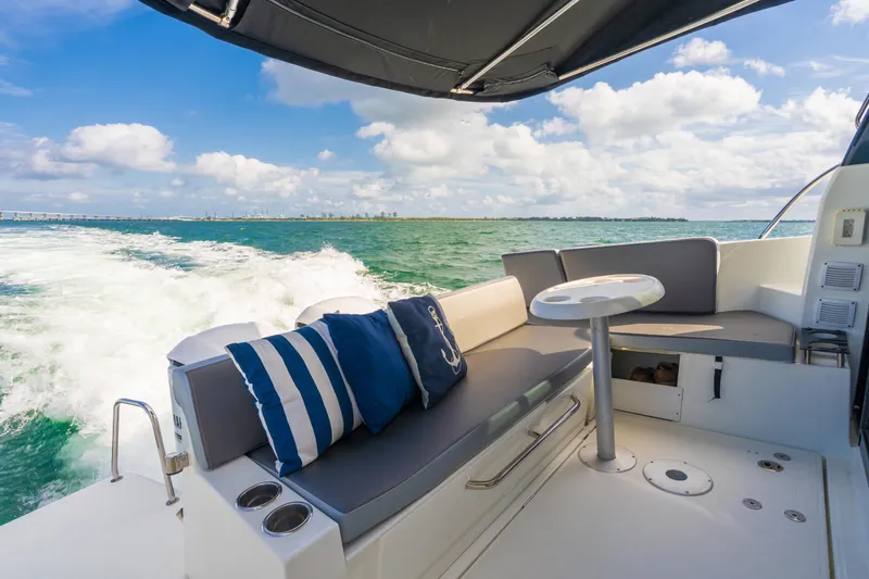  Yacht Photos Pics Jeanneau NC 1095 boat interior, 2019 model, cruising on open water with seating area.