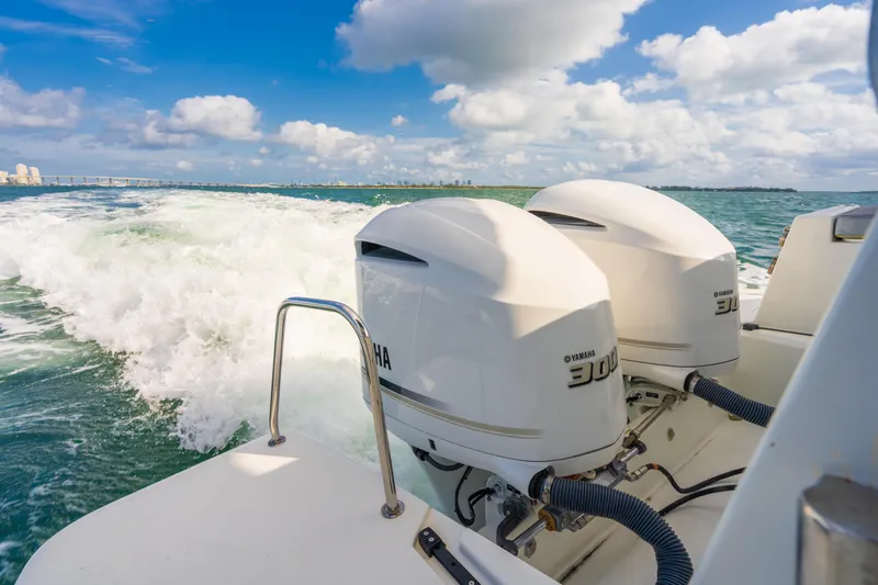  Yacht Photos Pics Jeanneau NC 1095 boat with dual Yamaha engines cruising on open water, 2019 model.