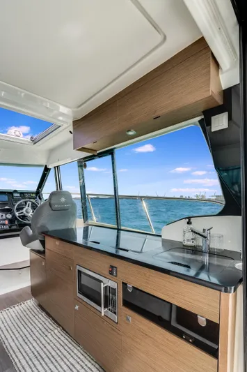  Yacht Photos Pics Interior of 2019 Jeanneau NC 1095 boat with modern kitchen and ocean view.