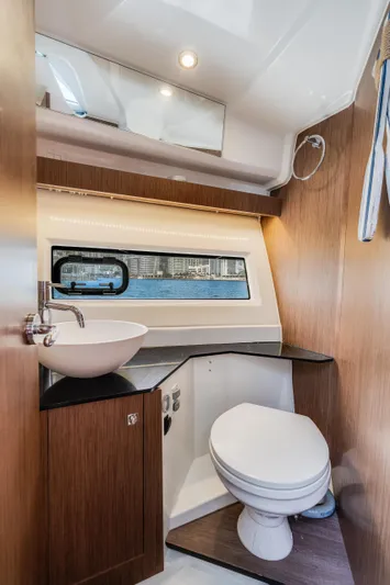  Yacht Photos Pics 2019 Jeanneau NC 1095 boat bathroom with modern fixtures and window view.