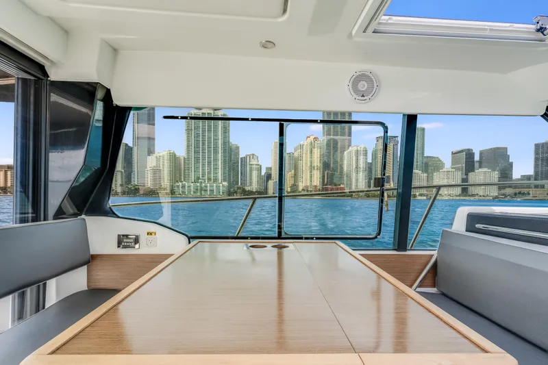  Yacht Photos Pics Interior view of 2019 Jeanneau NC 1095 yacht with city skyline in background.