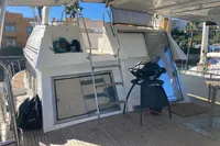 Deck of 1991 Trader 47 yacht with ladder, grill, and seating area.