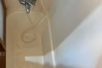 Shower area in 1991 Trader 47 boat with faucet and basket.