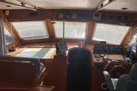 Interior view of 1991 Trader 47 yacht cockpit with navigation equipment and steering wheel.